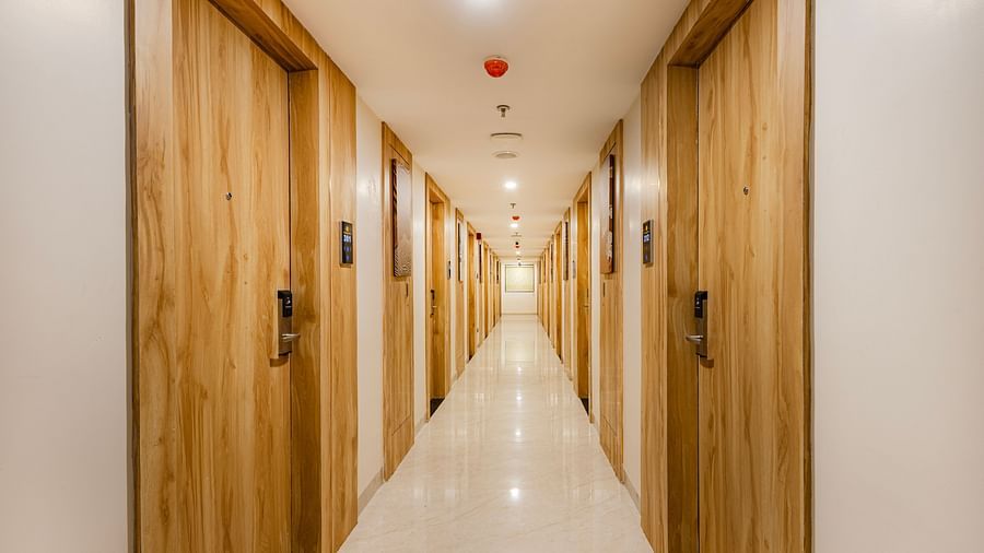 Lemonridge Hotels, KPHB | Hotel hallway with light-colored walls and doors to rooms